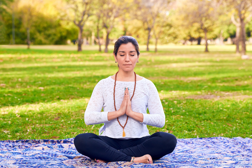 woman-doing-reiki-yoga-pose-park-chakra-pose